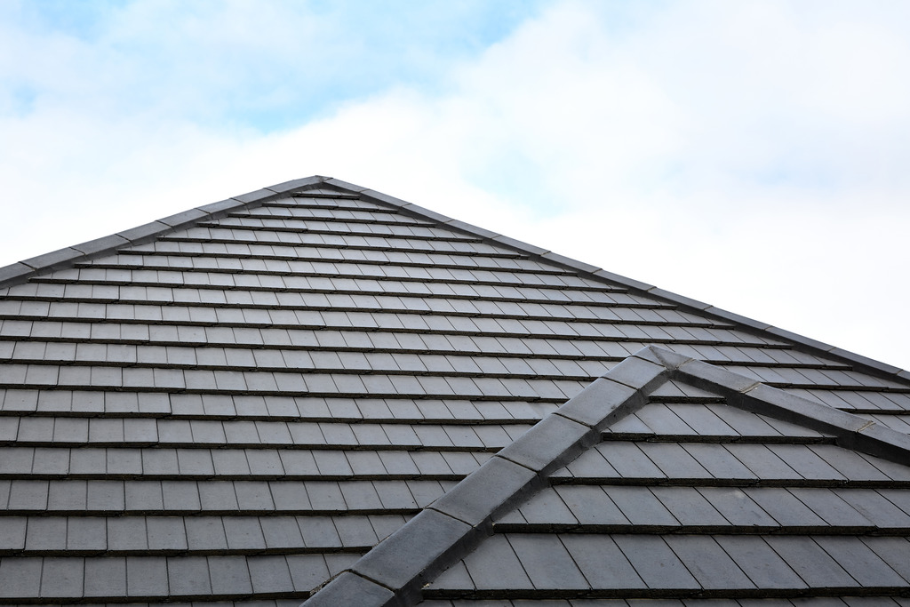 Monier dark roof tiles with clouds and sky.