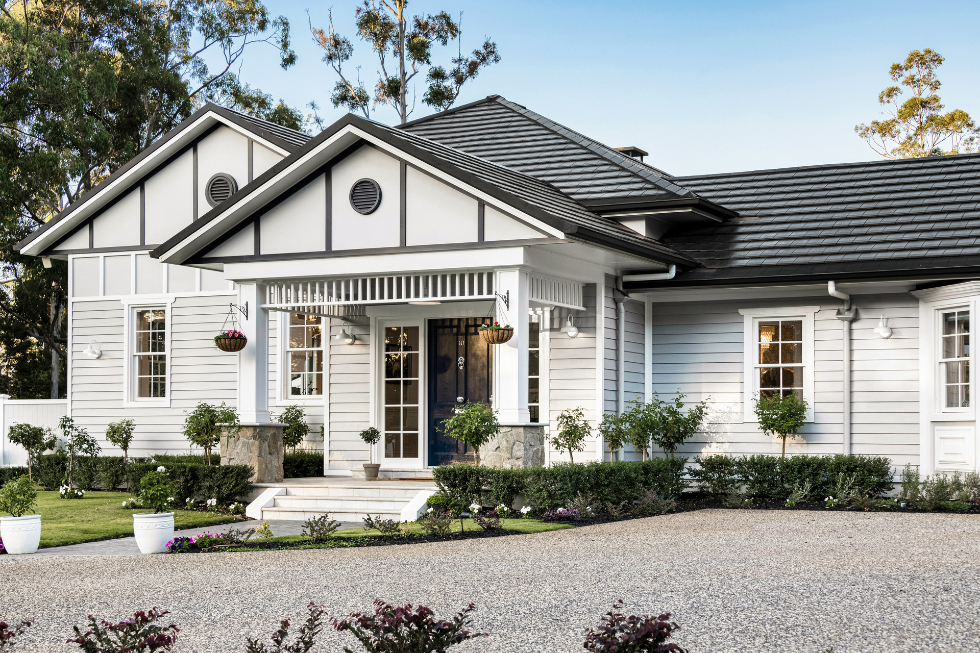 Monier roof tiles on residential home with front lawn and garden.