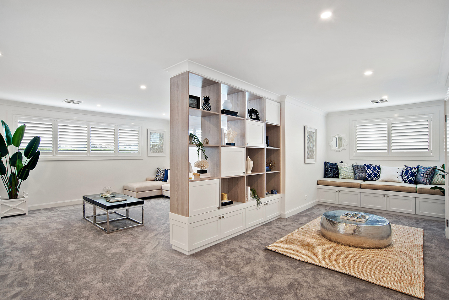 Library style living area with box pigeon hole storage breaking the room up.