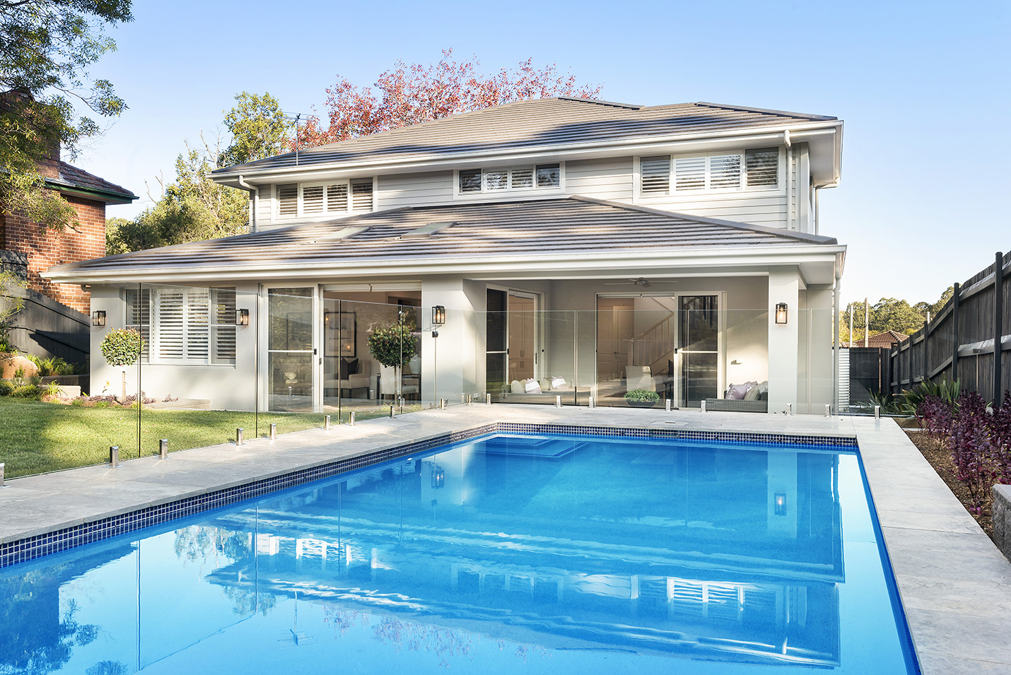 Knockdown and rebuilding for profit with Monier Roofing Open style Hamptons living area with two sofas facing each other.
